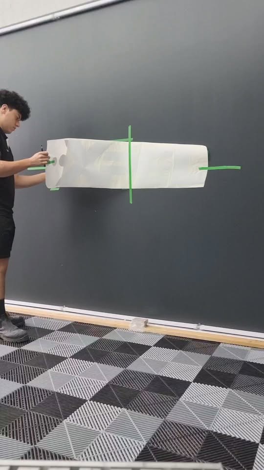 Applying film to a glass panel in the workshop